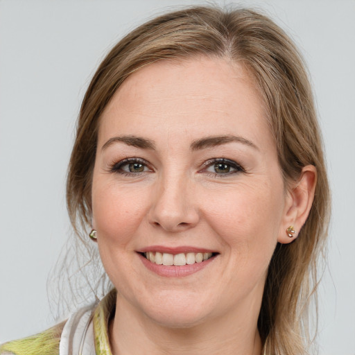 Joyful white young-adult female with long  brown hair and blue eyes