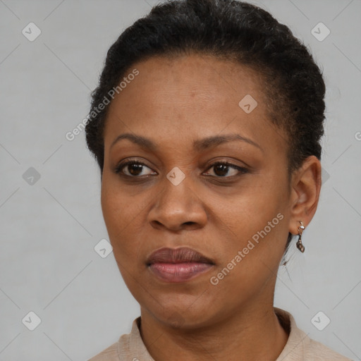 Joyful black adult female with short  brown hair and brown eyes