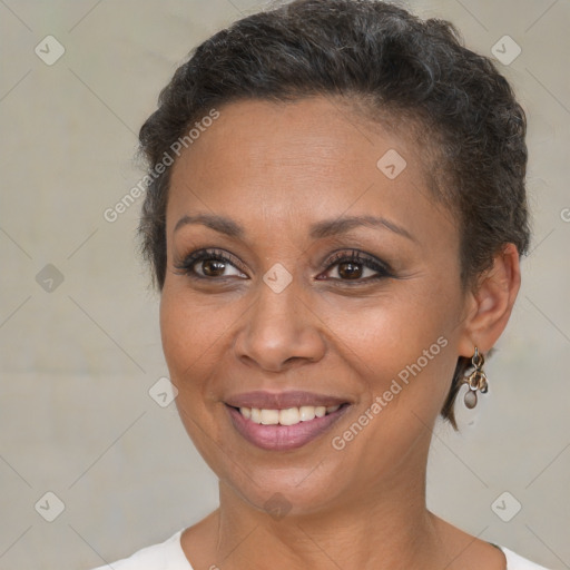 Joyful black adult female with short  brown hair and brown eyes