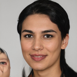 Joyful white young-adult female with medium  black hair and brown eyes