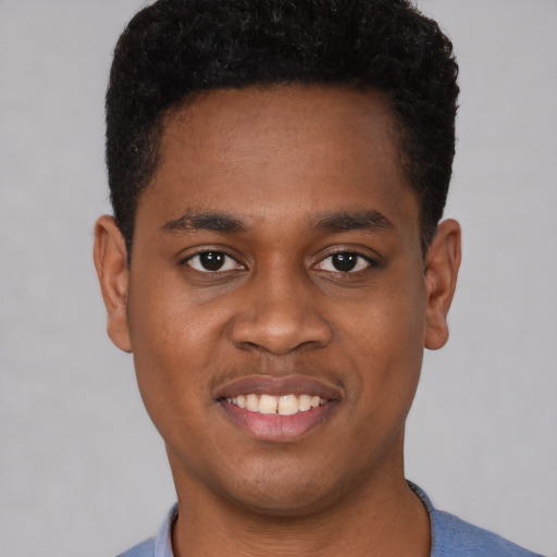 Joyful black young-adult male with short  brown hair and brown eyes