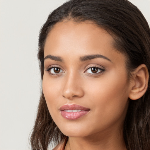 Joyful latino young-adult female with long  brown hair and brown eyes