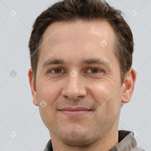 Joyful white adult male with short  brown hair and brown eyes