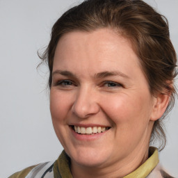 Joyful white adult female with medium  brown hair and brown eyes