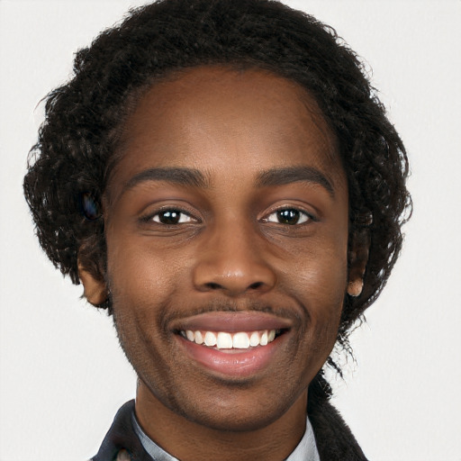 Joyful black young-adult male with long  brown hair and brown eyes