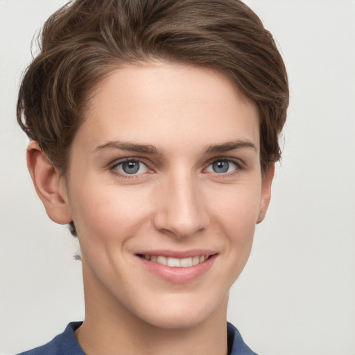 Joyful white young-adult female with short  brown hair and grey eyes