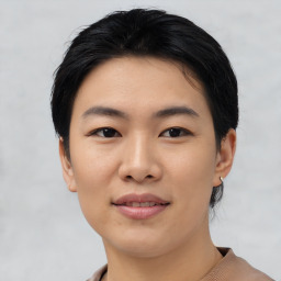 Joyful asian young-adult female with short  black hair and brown eyes