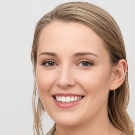 Joyful white young-adult female with long  brown hair and grey eyes