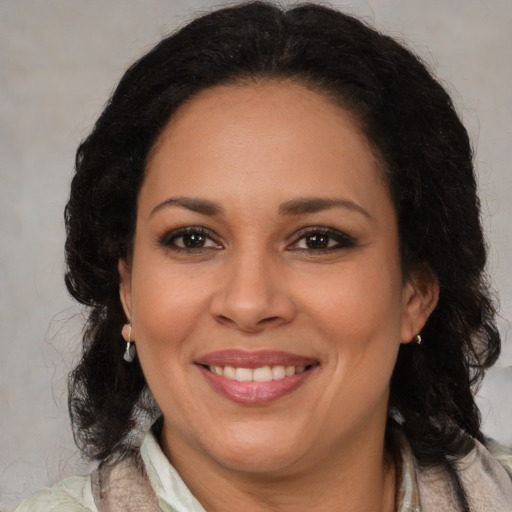 Joyful black adult female with medium  brown hair and brown eyes