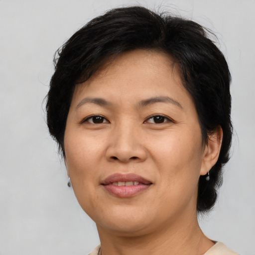 Joyful asian adult female with medium  brown hair and brown eyes