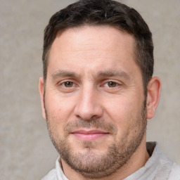 Joyful white adult male with short  brown hair and brown eyes