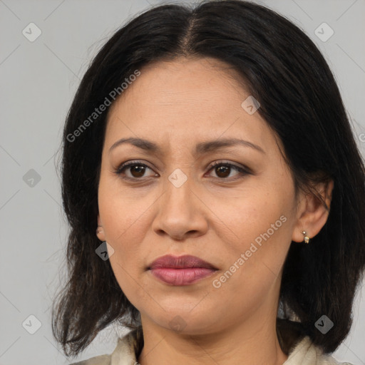 Joyful latino adult female with medium  brown hair and brown eyes