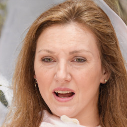 Joyful white adult female with long  brown hair and brown eyes