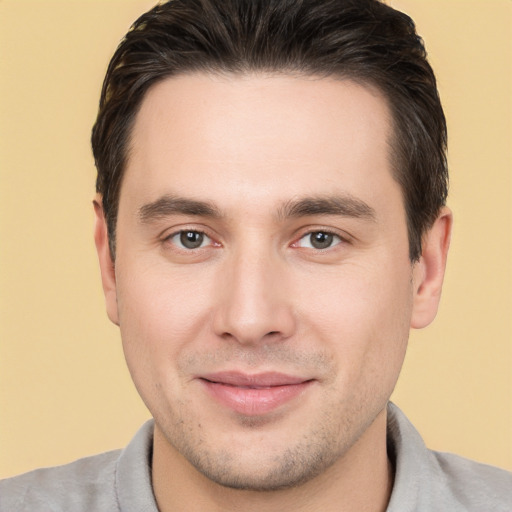 Joyful white young-adult male with short  brown hair and brown eyes