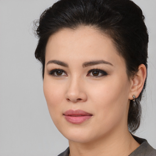 Joyful asian young-adult female with medium  black hair and brown eyes