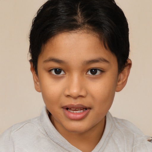 Joyful latino child female with short  brown hair and brown eyes