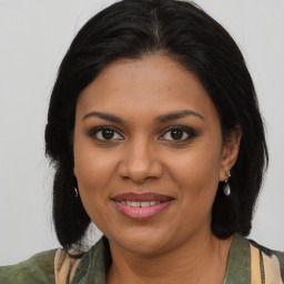 Joyful black young-adult female with medium  brown hair and brown eyes