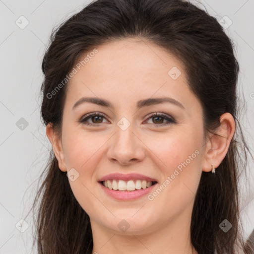 Joyful white young-adult female with long  brown hair and brown eyes