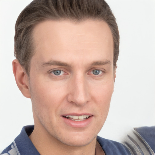 Joyful white young-adult male with short  brown hair and grey eyes