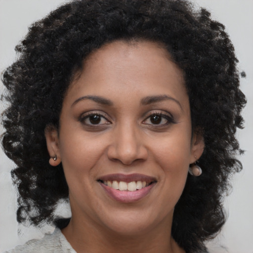 Joyful black young-adult female with medium  brown hair and brown eyes