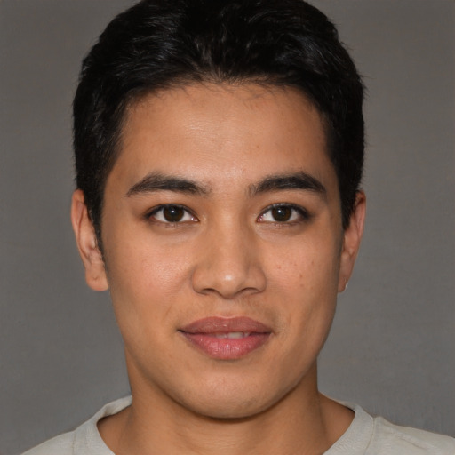 Joyful latino young-adult male with short  brown hair and brown eyes