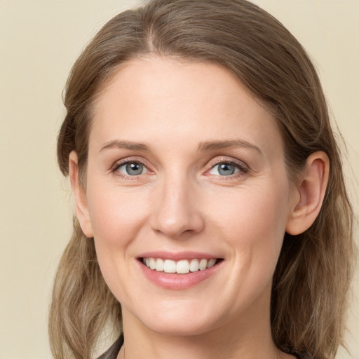 Joyful white young-adult female with medium  brown hair and grey eyes