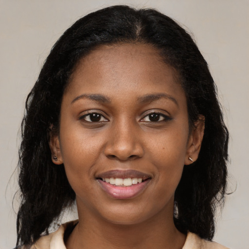 Joyful latino young-adult female with medium  brown hair and brown eyes