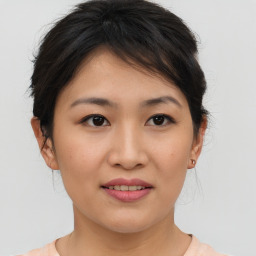 Joyful asian young-adult female with medium  brown hair and brown eyes