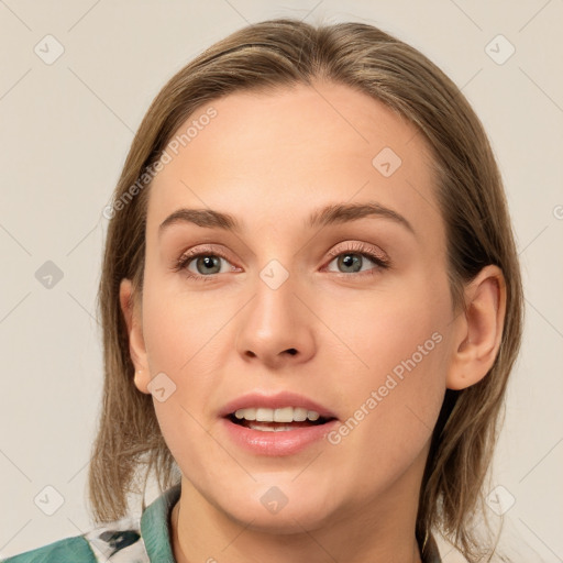 Joyful white young-adult female with medium  brown hair and blue eyes