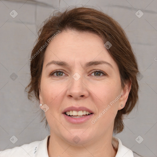 Joyful white adult female with medium  brown hair and grey eyes