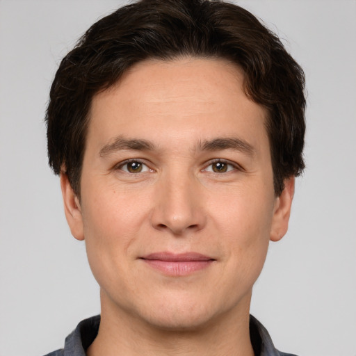 Joyful white adult male with short  brown hair and brown eyes