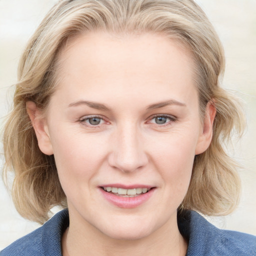 Joyful white young-adult female with medium  brown hair and blue eyes