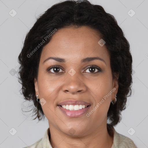 Joyful black adult female with medium  brown hair and brown eyes