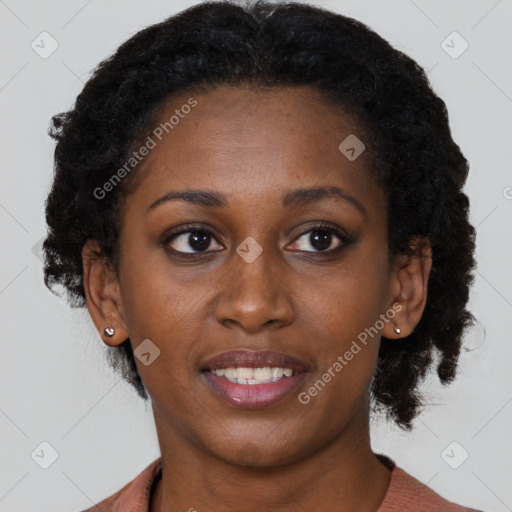 Joyful black young-adult female with medium  black hair and brown eyes