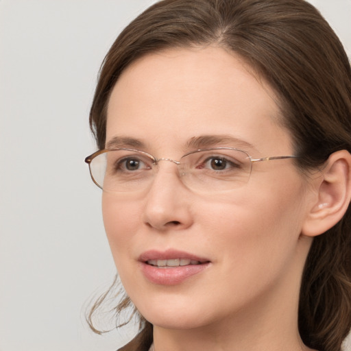 Joyful white adult female with long  brown hair and brown eyes