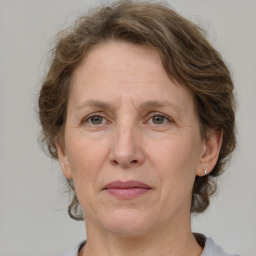 Joyful white adult female with medium  brown hair and grey eyes