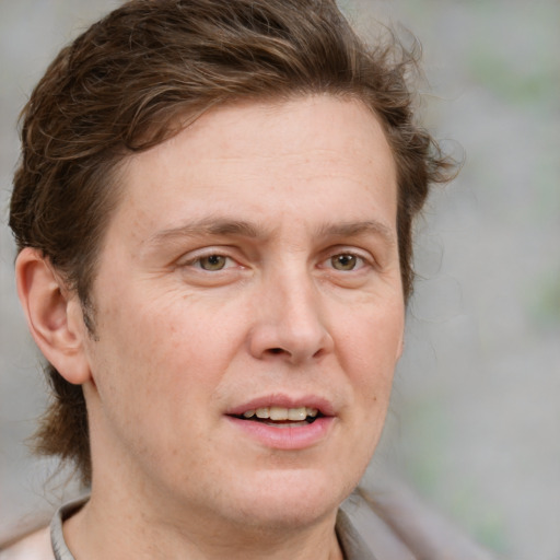 Joyful white adult male with medium  brown hair and grey eyes