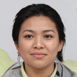 Joyful asian young-adult female with medium  brown hair and brown eyes