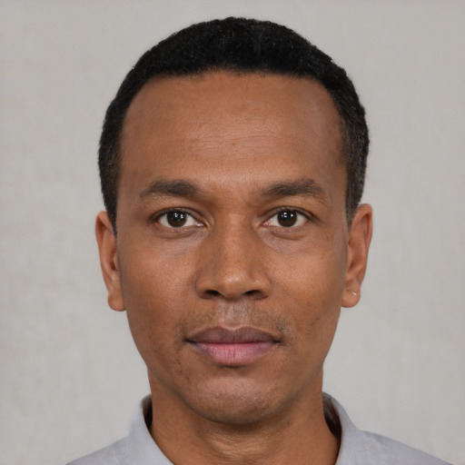 Neutral latino adult male with short  black hair and brown eyes