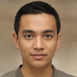 Joyful latino young-adult male with short  brown hair and brown eyes