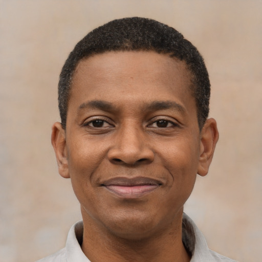 Joyful black young-adult male with short  black hair and brown eyes