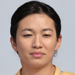 Joyful asian young-adult female with short  brown hair and brown eyes