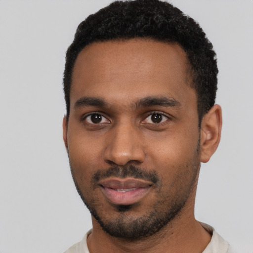 Joyful black young-adult male with short  black hair and brown eyes