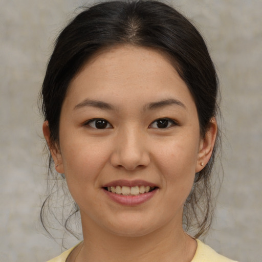 Joyful asian young-adult female with medium  brown hair and brown eyes