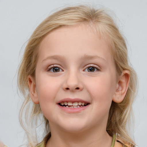 Joyful white child female with medium  brown hair and blue eyes