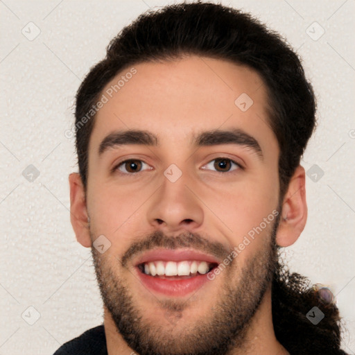 Joyful white young-adult male with short  black hair and brown eyes