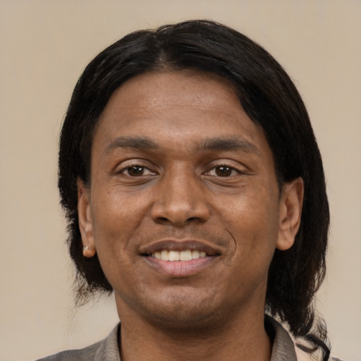 Joyful latino young-adult male with medium  black hair and brown eyes