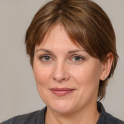 Joyful white adult female with medium  brown hair and grey eyes