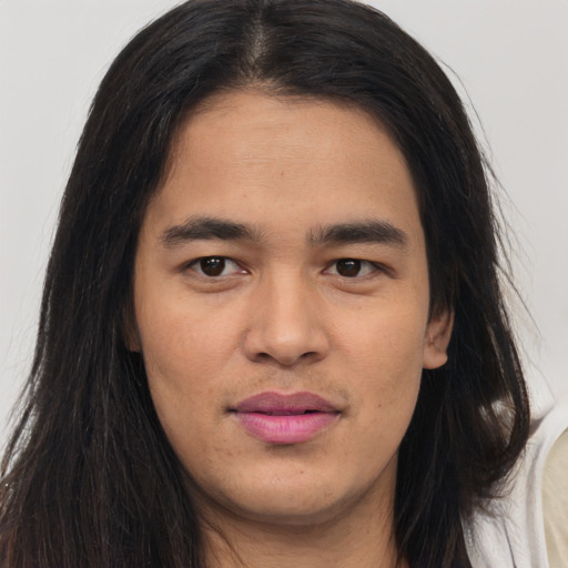 Joyful asian young-adult male with long  brown hair and brown eyes