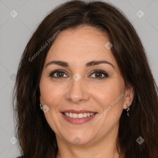 Joyful white adult female with long  brown hair and brown eyes